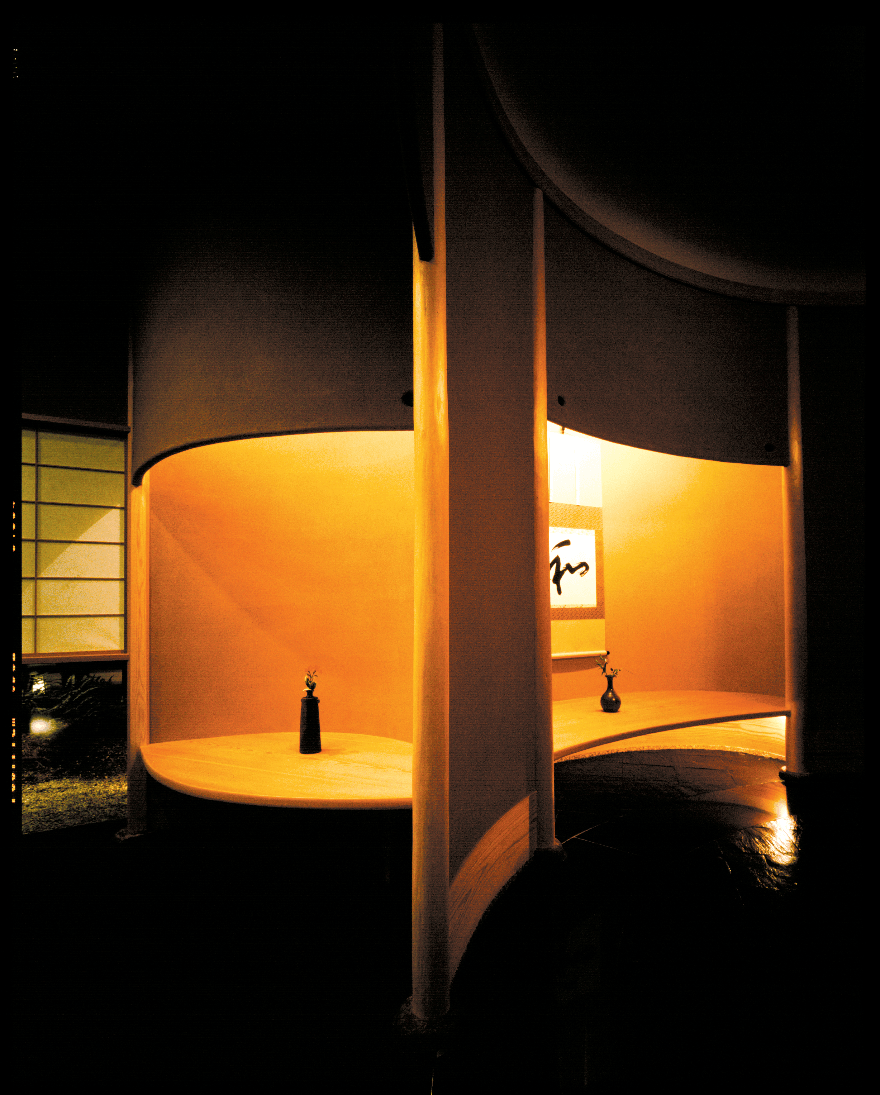 minimalist japanese hotel corridor with soft plaster walls, warm ambient lighting, zen architecture