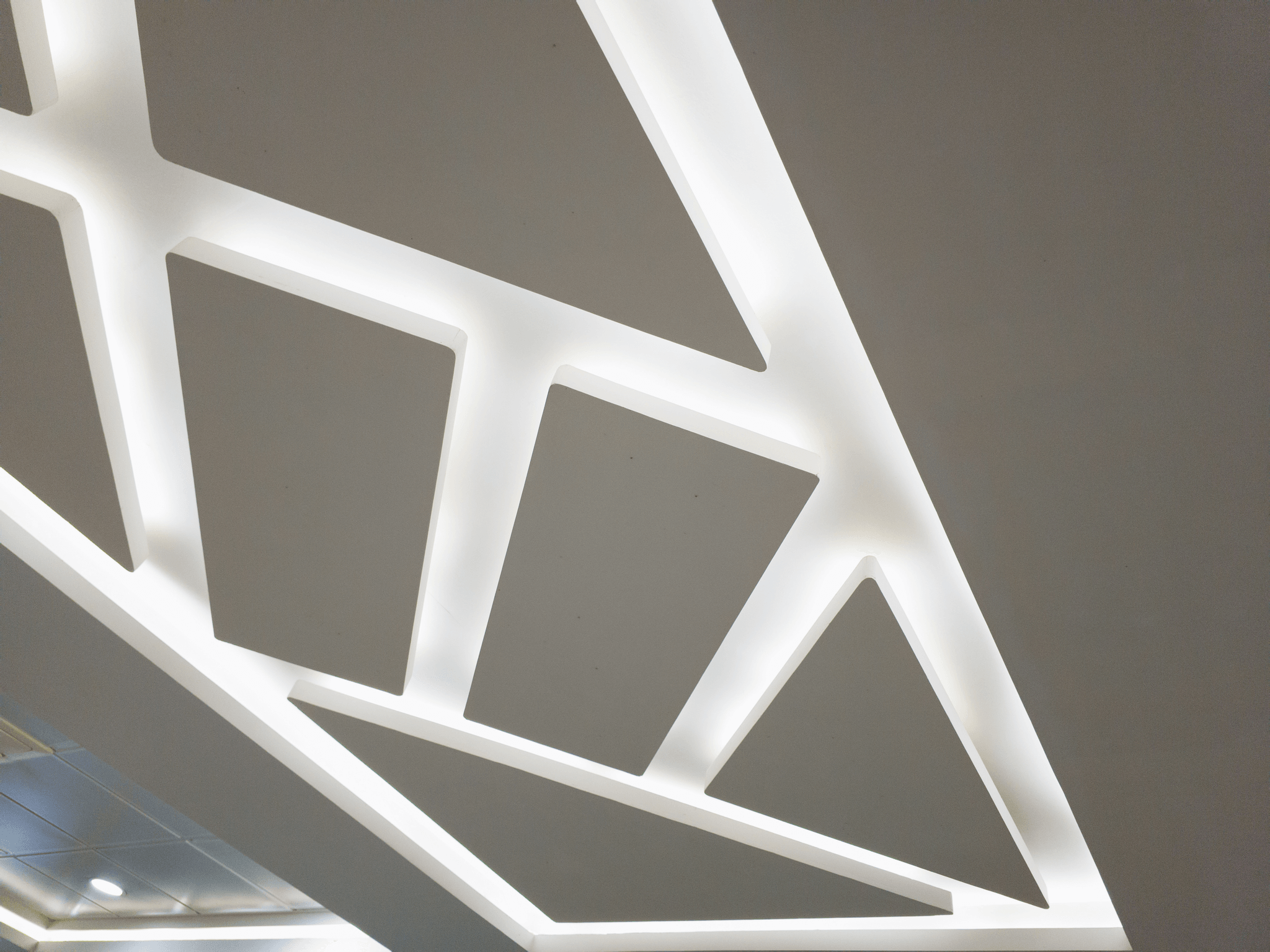 Sculptural wood ceiling with warm indirect architectural lighting