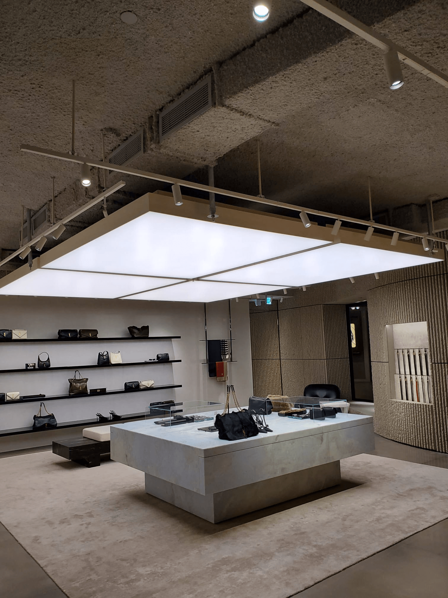 modern residential interior with bold rough textured ceiling finish, dramatic ambient lighting, expressive design
