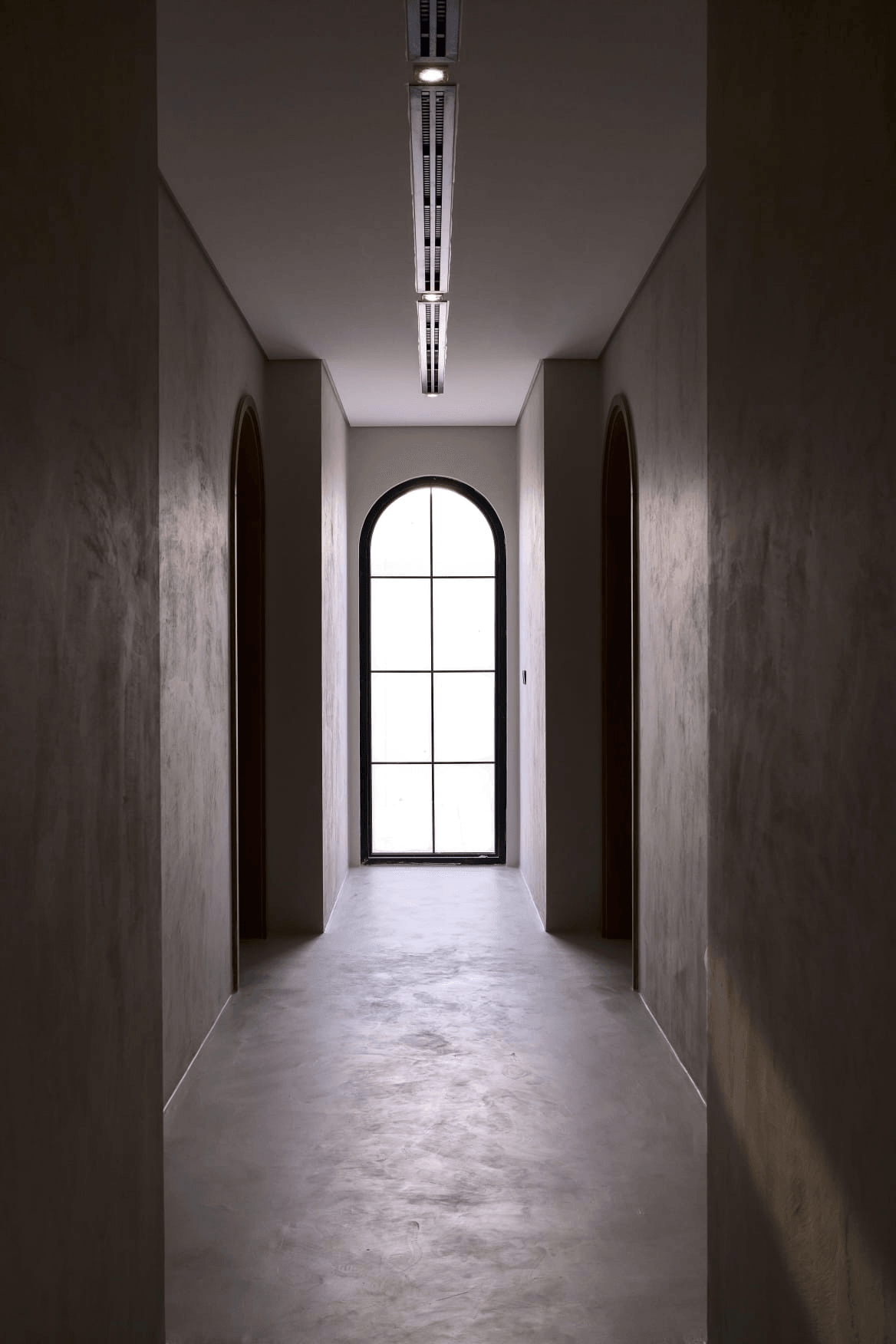 contemporary bathroom interior with seamless microcement flooring and walls, warm minimalist atmosphere