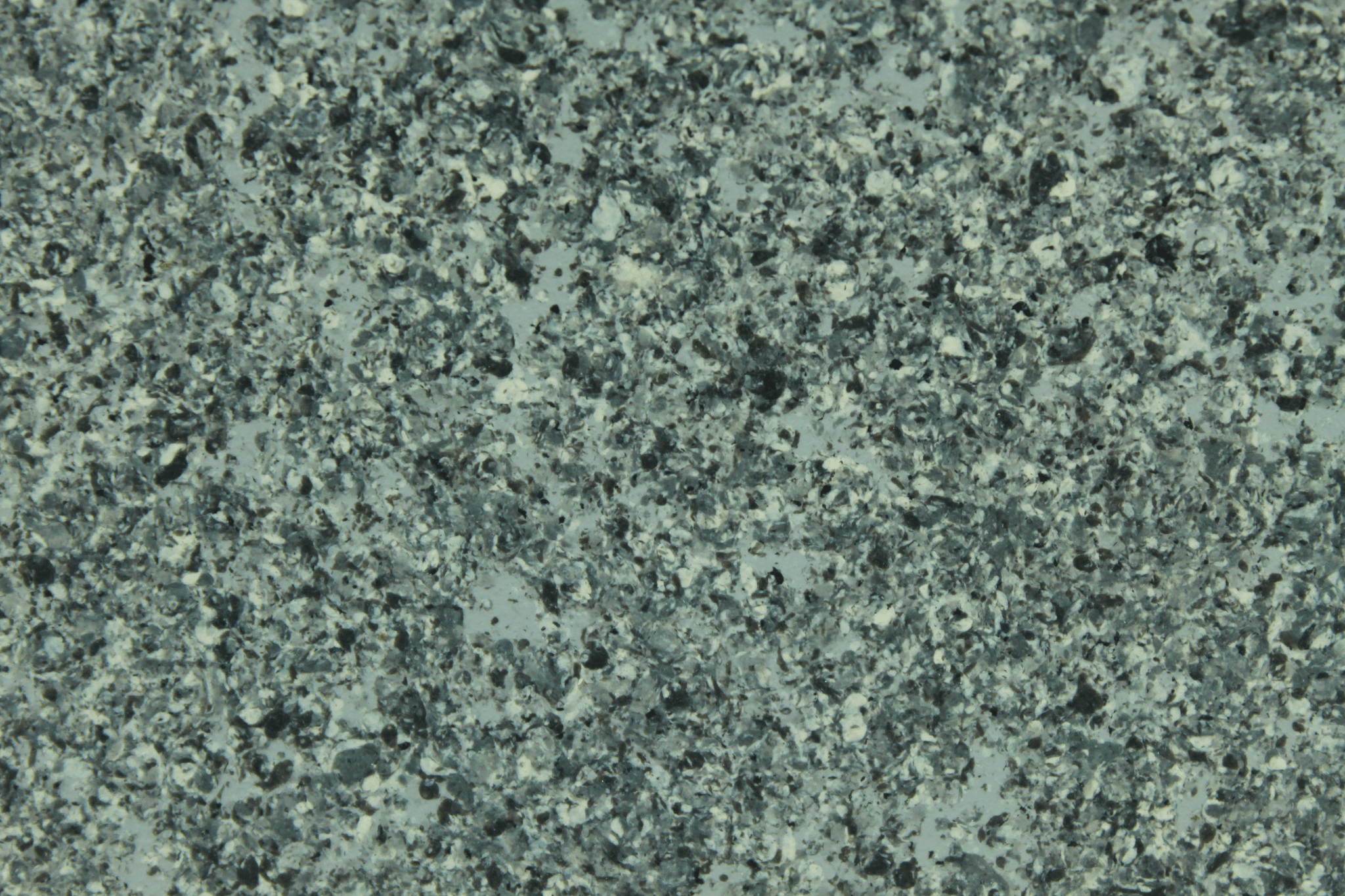 macro texture of rustic orange granite finish with iron oxide mineral flakes