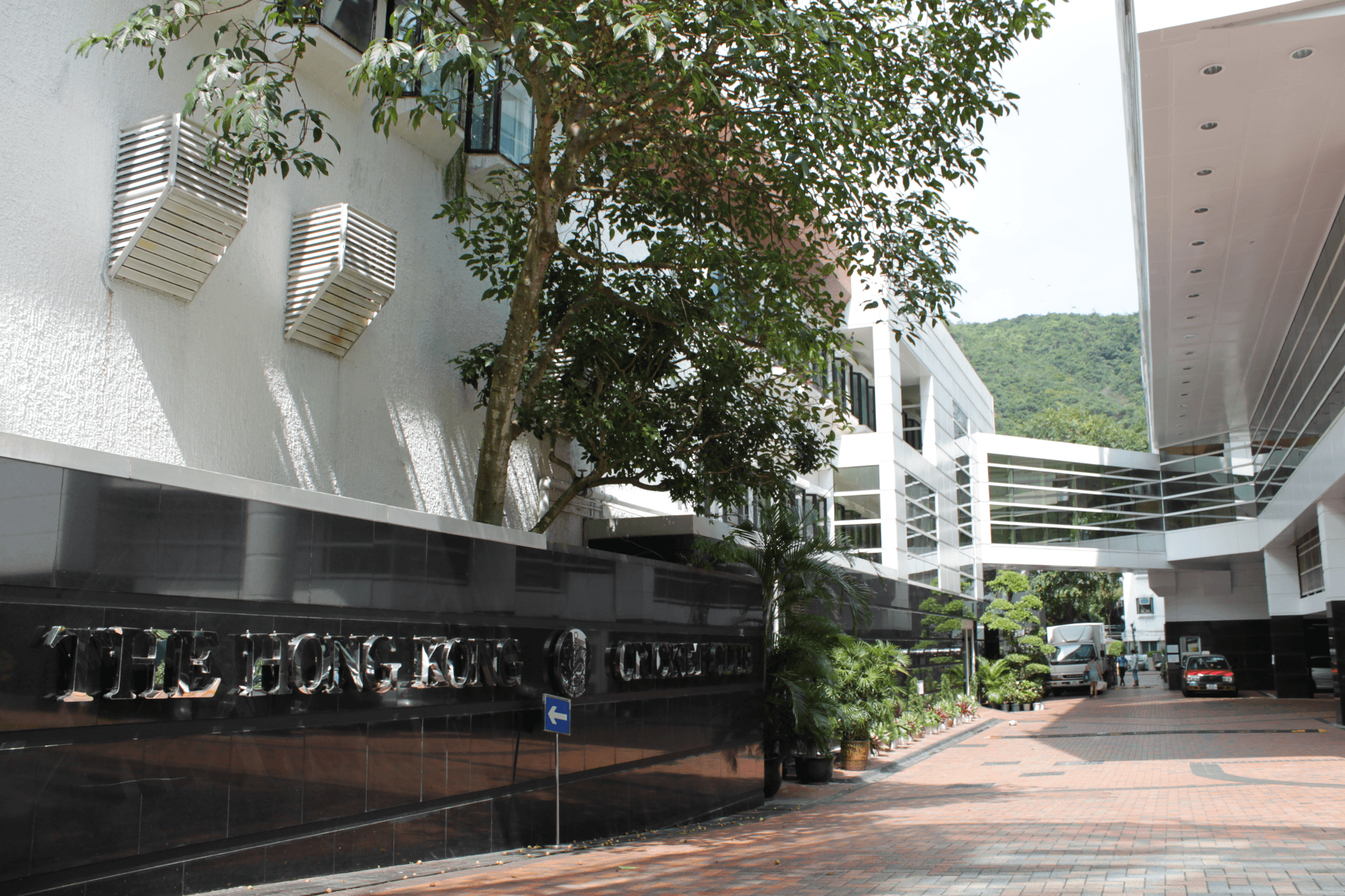 minimalist corporate pavilion with textured coating finish, evening lighting, architectural design
