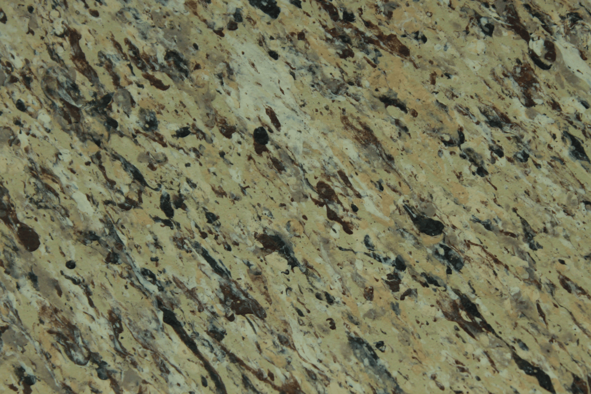 macro texture of light tan granite finish with brown flakes