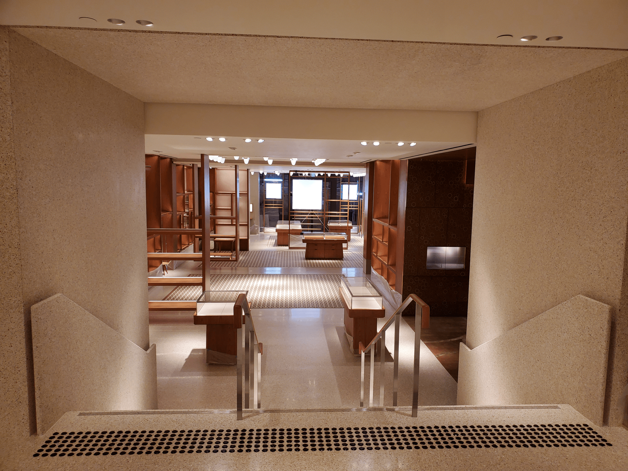 boutique hotel lobby with colorful epoxy terrazzo flooring, warm lighting, high-end architectural in