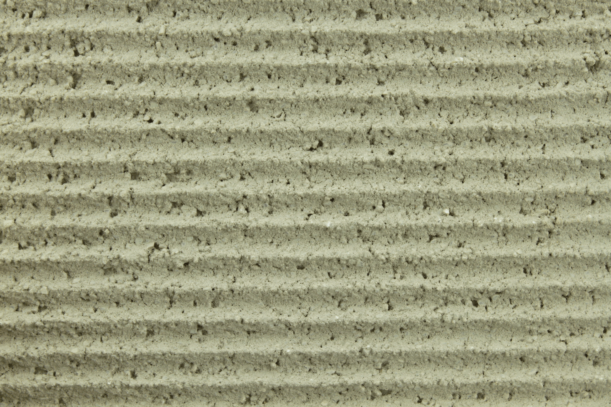 macro texture of earth beige italian aggregate plaster, warm sandy mineral grains