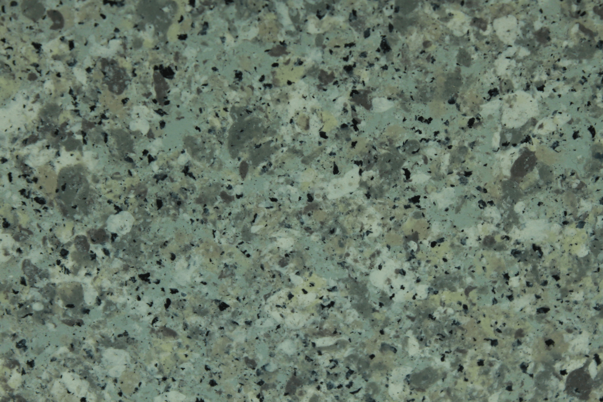 macro texture of olive granite finish with green mineral flakes