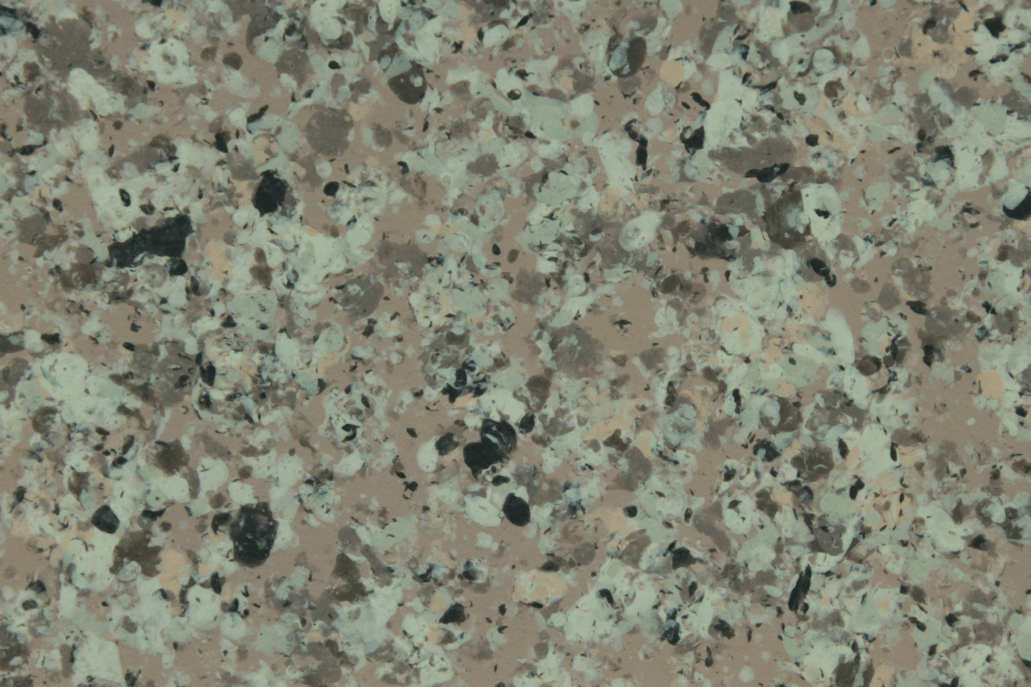 macro texture of blueish grey granite finish with cold mineral flakes
