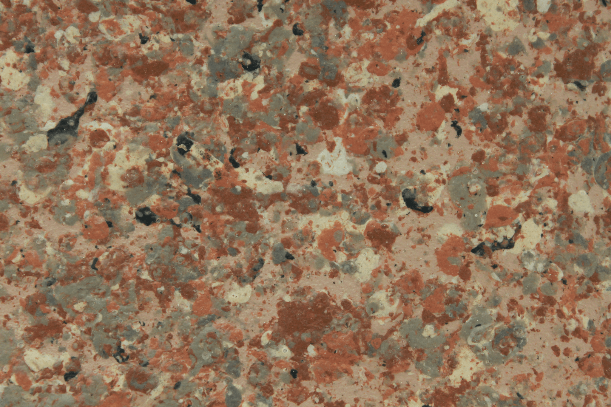 macro texture of soft ivory granite finish with subtle grey mineral specks