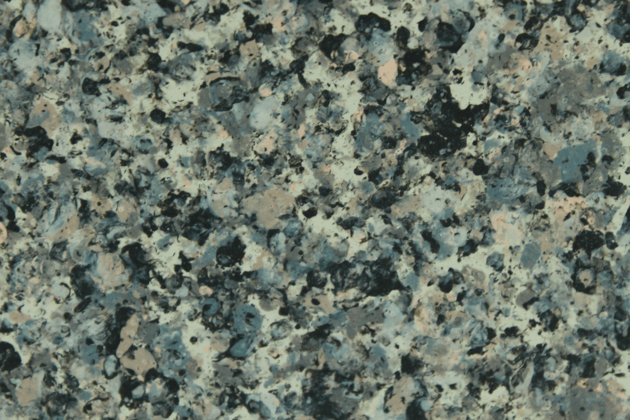 macro texture of earthy brown granite finish with mixed quartz and mineral flakes