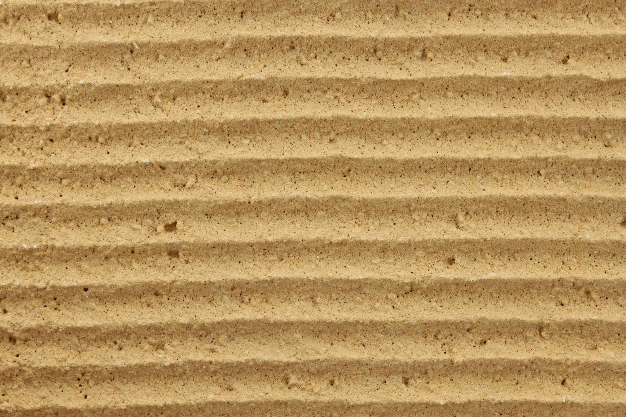 macro texture of roman slate italian aggregate plaster, dark charcoal mineral grains